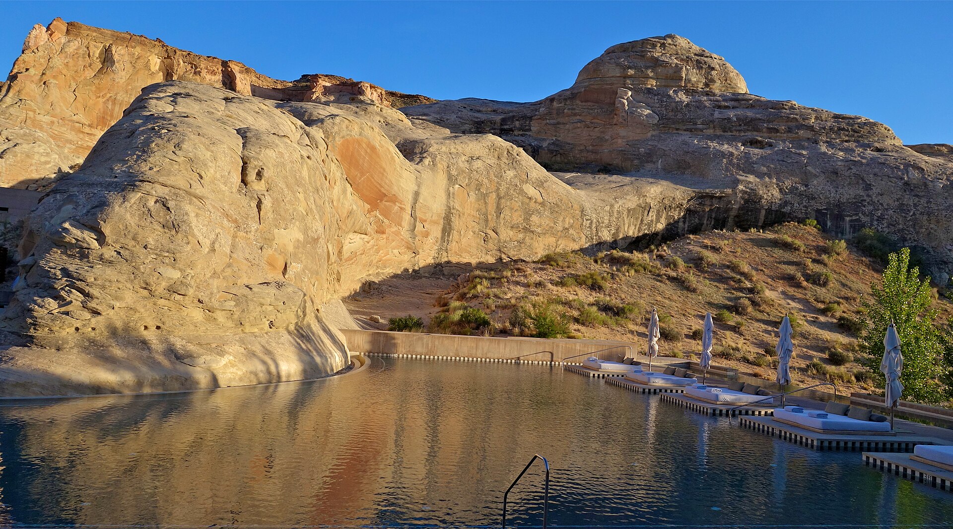 Amangiri’s main pool curves around a desert rock formation in southern Utah.